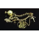 A gold bracelet (unmarked) hung with various charms including 9ct helicopter, aeroplane,