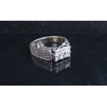 A white gold ring with textured band set with six bright cut diamonds, stamped 18ct. Size K, 4.