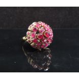 A gold ruby cluster ring in domed setting, stamped 14k. Size L, 5.