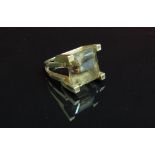 A square cut smoky quartz ring set in high four claw mount and split shank stamped 14k. Size J, 12.