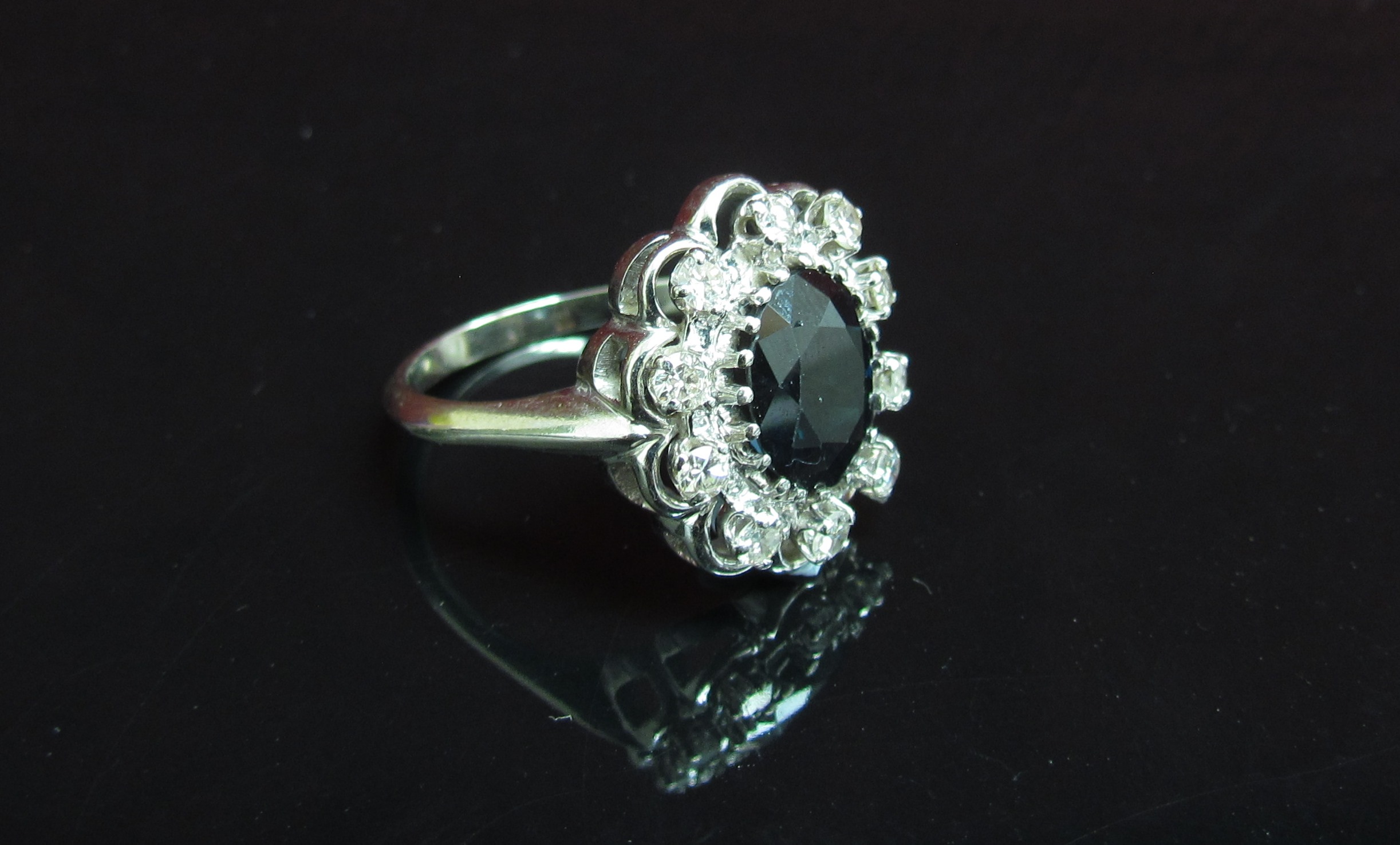 A white gold sapphire and diamond cluster ring, shank stamped 18k. Size R, 6. - Image 2 of 2