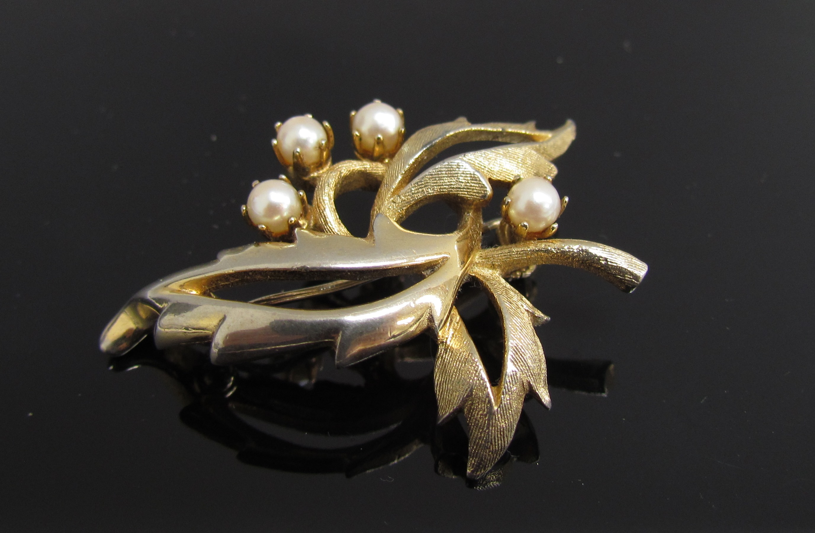 A foliate pearl set brooch