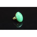 An Oriental gold ring with oval jade cabochon. Size J, 5.
