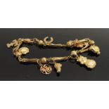 A 9ct gold charm bracelet set with nine charms including cat, chick, rabbit, horseshoe,