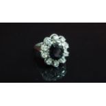 A white gold sapphire and diamond cluster ring, shank stamped 18k. Size R, 6.