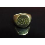 A gold signet ring stamped 18. Size R, 13.