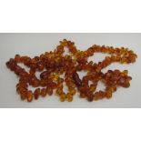 Two amber bead necklaces, 70cm and 60cm long, 73.