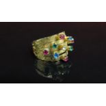 A gold ring with five bands all set with coloured stones. Size O, 4.