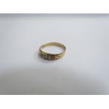 A gold ring set with small diamonds and pearls, scroll shoulders. Size T, 2.