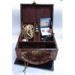 A jewellery box with some contents including rings, faux pearl necklaces,