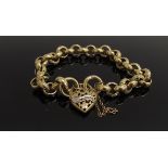 A gold engraved link bracelet with pierced heart padlock set with a row of diamonds (one missing),