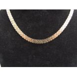 A 9ct gold three tone flat link necklace, 41cm long, 32.