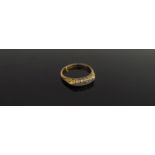 A 22ct gold ring set with five small diamonds, scroll engraved mount. Size N, 3.