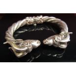 A heavy twisted white metal bangle with rams head terminals and locking hinge, stamped 900. 85.