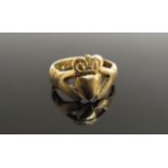 A gold Frienship ring, hands holding a crowned heart, unmarked,