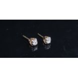 A pair of diamond stud earrings, no backs, 0.