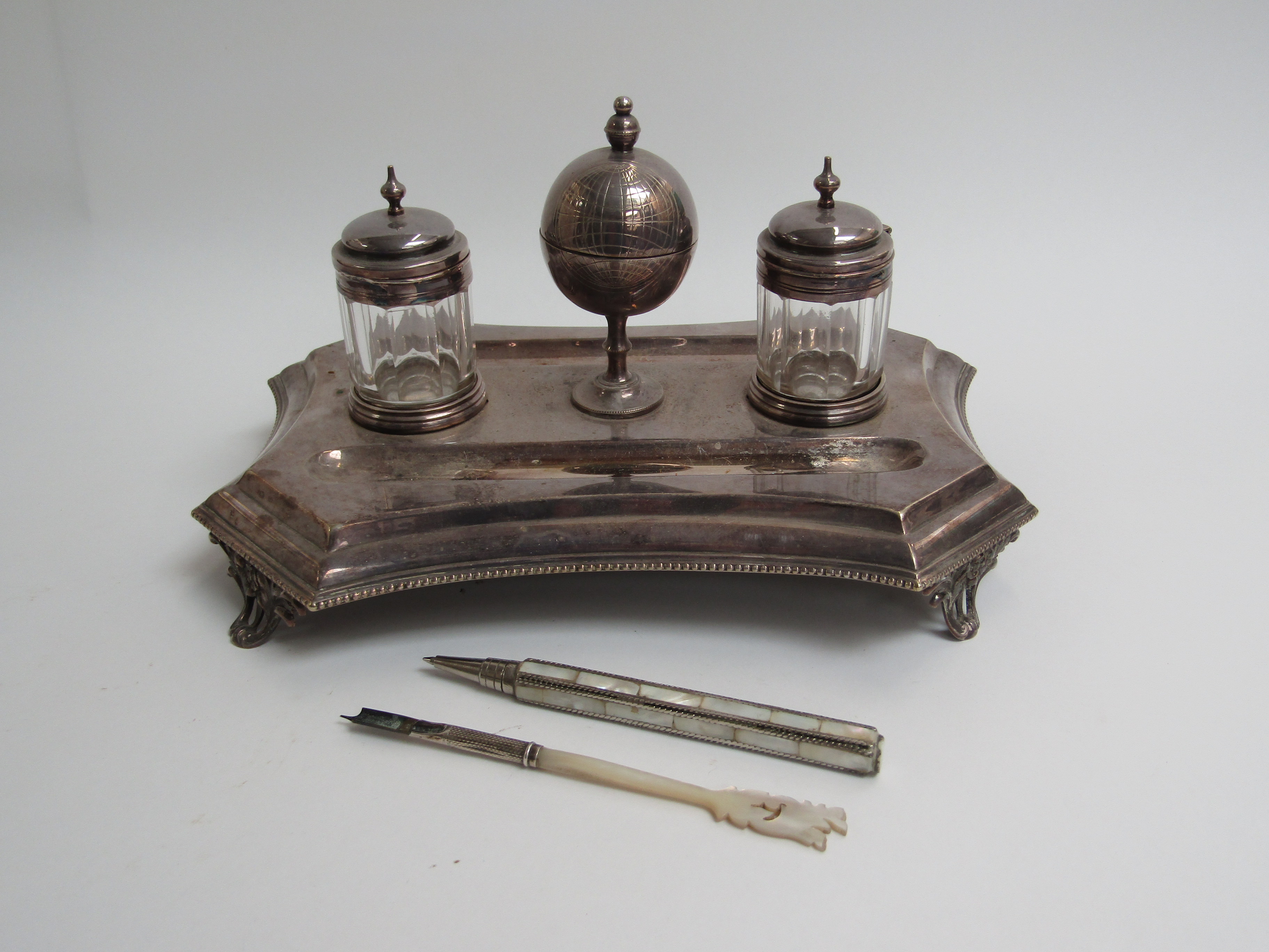 A silver plate desk stand with central globe container,