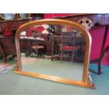 A modern classical gilded overmantel wall mirror with bevelled glass, foliate relief,