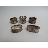 Five silver and sterling napkin rings including two with elephant detail,