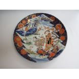 A late 19th Century Japanese charger figures in garden with vivid blue border 46cm diameter,