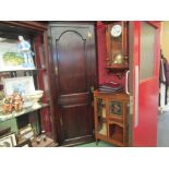 A George III oak country house two door full height corner cupboard with painted interior over a