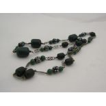 An aesthetic movement flapper style necklace with green cassein beads (early plastic),