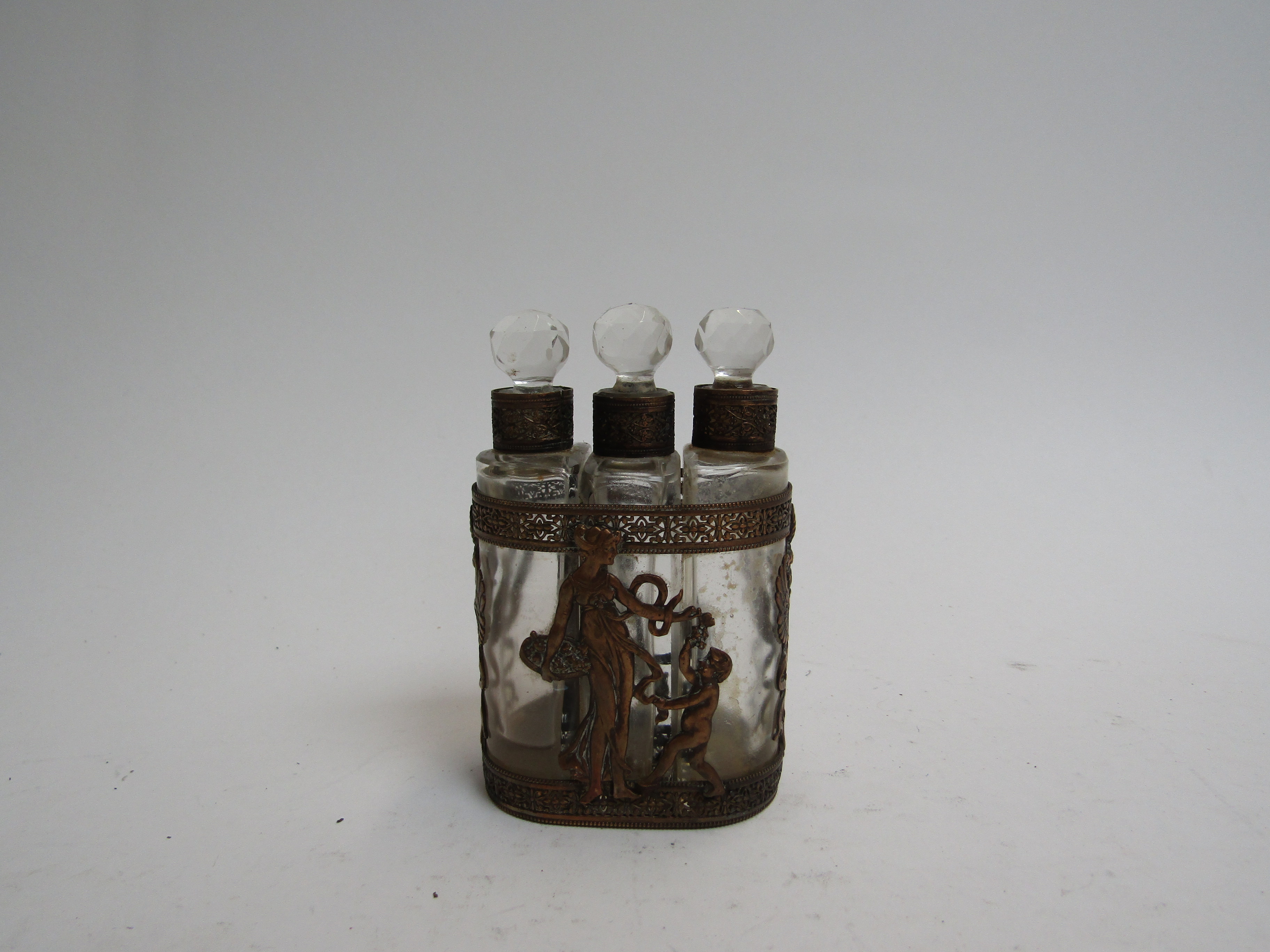 An Edwardian three bottle scent bottle in ornate case,