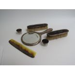 A tortoiseshell and silver banded dressing table items including mirror,