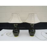 A pair of modern green ceramic lamp bases with pierced Art Nouveau shades,