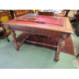 In the manner of "Maple & Co" a Victorian carved oak desk with single frieze drawer the tooled