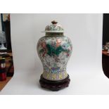 A modern Oriental canton style vase with lid on carved wood stand, vase 44cm tall,