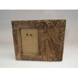 A carved wooden easel back photograph frame with giraffe design