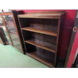 An oak height adjustable two shelf bookcase on a plinth base,