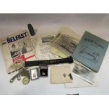 A collection of items relating to HMS Belfast including Bosun's whistle,