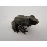 A limited edition bronze baby frog,
