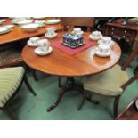 A George III flame mahogany circular tilt top wine table on vase shaped turned column and pad foot