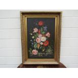 A late 19th/early 20th Century Dutch style still life of flowers on mantel piece in highly ornate