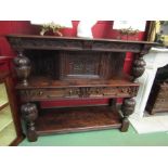 A 17th Century style carved oak press cupboard with single door over two drawers and pot board on
