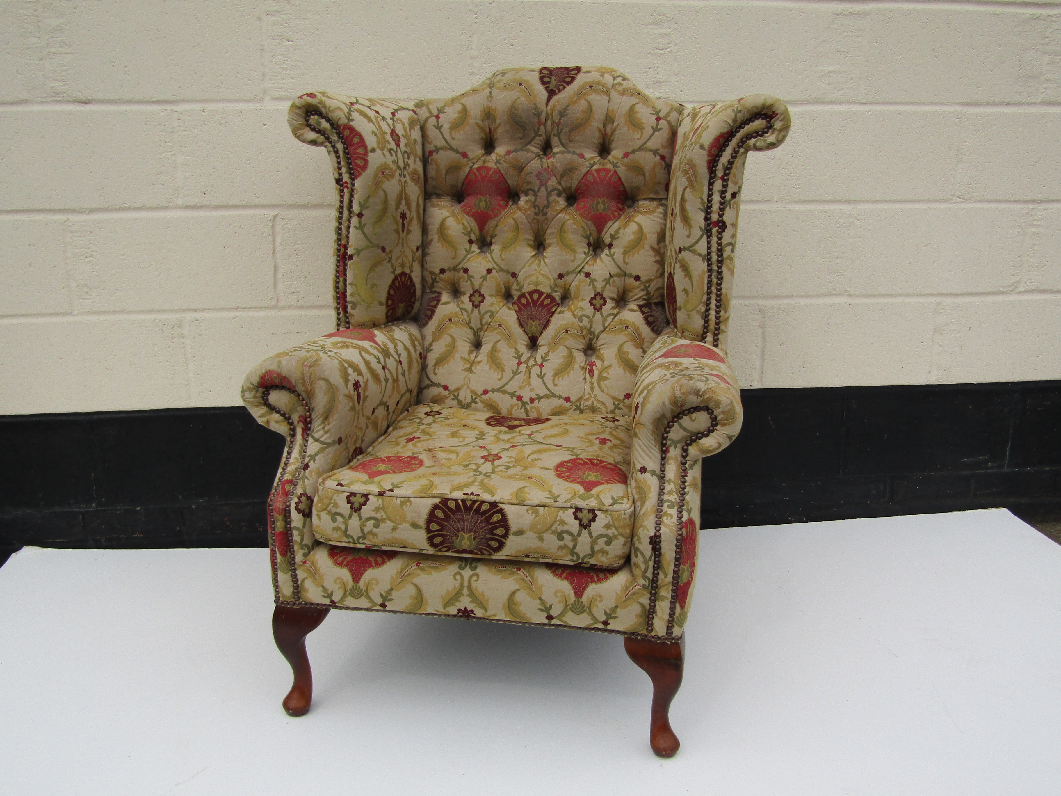 Plumbs Silk upholstered wingback armchair with button back, discolouration to head rest and arms,