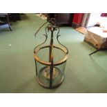 A Victorian style decorative brass and cylindrical glass hanging electric lantern,
