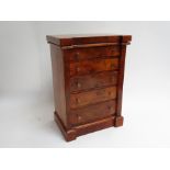 A walnut Apprentice chest of five drawers.
