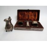 A Harrison & Hipwood Deco silver cruet set and associated silver cream jug,