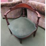 A late Victorian walnut corner chair on ring turned legs and brass castors,
