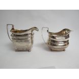 Two London Georgian silver milk jugs with ball feet. One marks are rubbed the other is T.