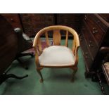 An Edwardian walnut tub shape chair on pad foot cabriole legs,