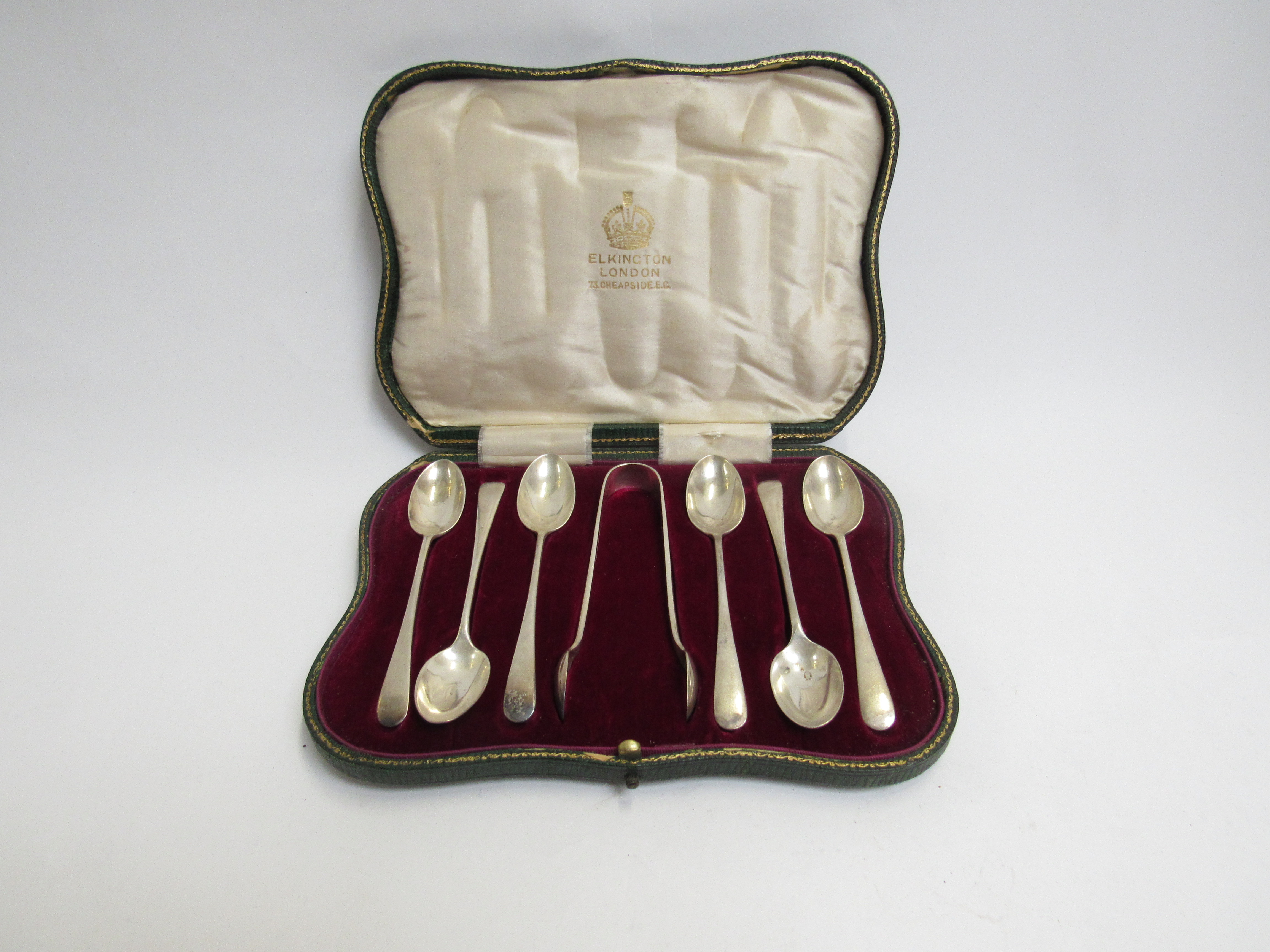 An Elkington set of six silver teaspoons and a pair of sugar nips, Birmingham 1911,