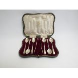 An Elkington set of six silver teaspoons and a pair of sugar nips, Birmingham 1911,