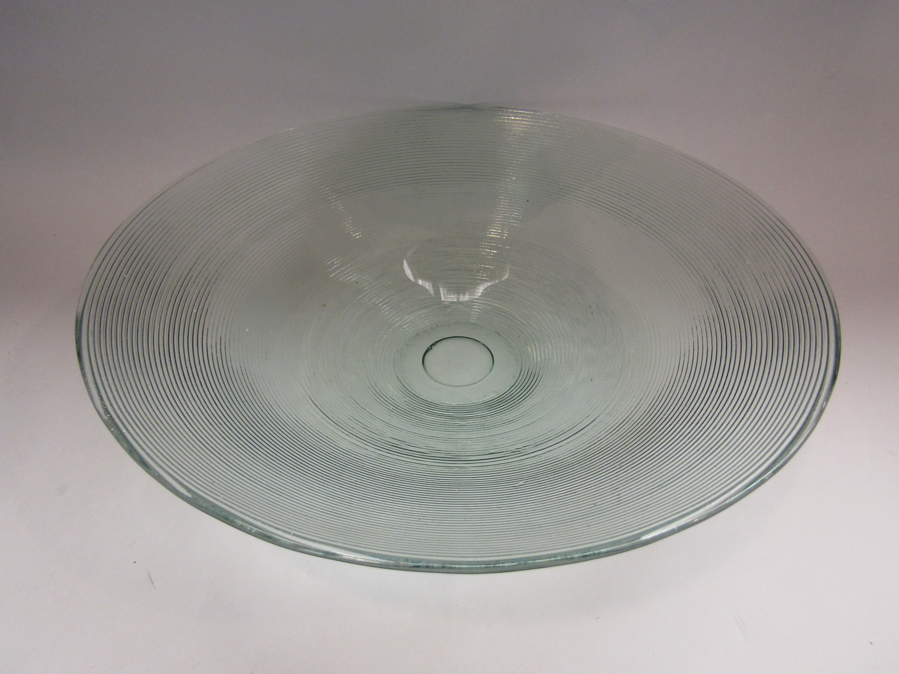 A recycled glass bowl with impressed concentric rings,