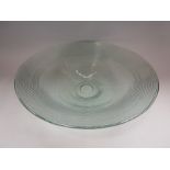 A recycled glass bowl with impressed concentric rings,