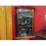 An Edwardian mahogany wall hanging corner cabinet with satinwood stringing and astragal glazing,